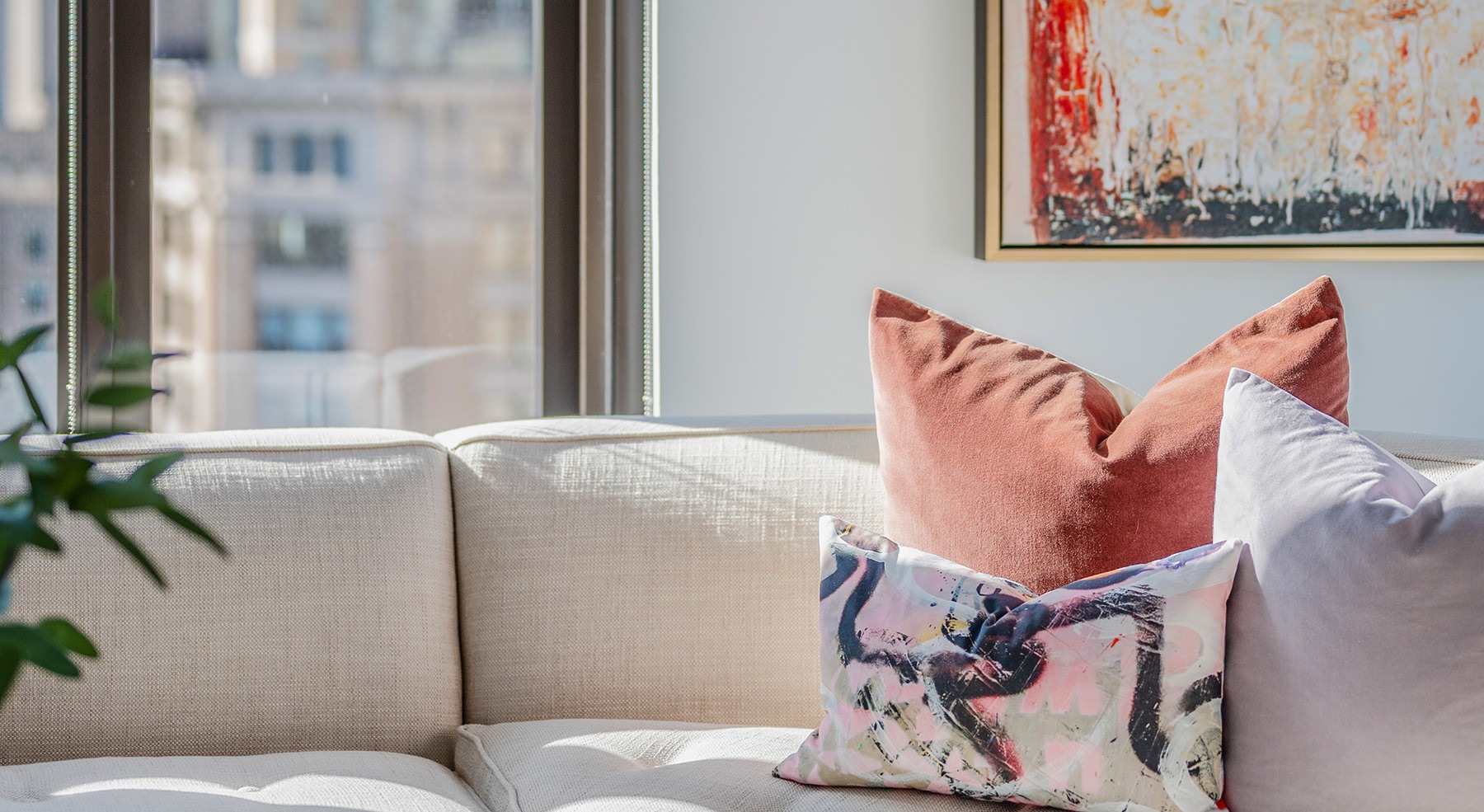 Spacious well lit living room with large floor to ceiling windows 
