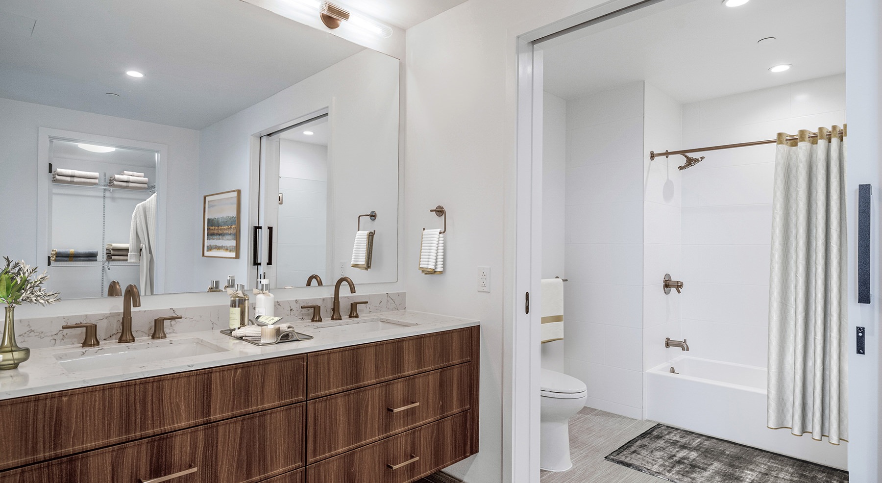 bathroom with large closet and two sinks